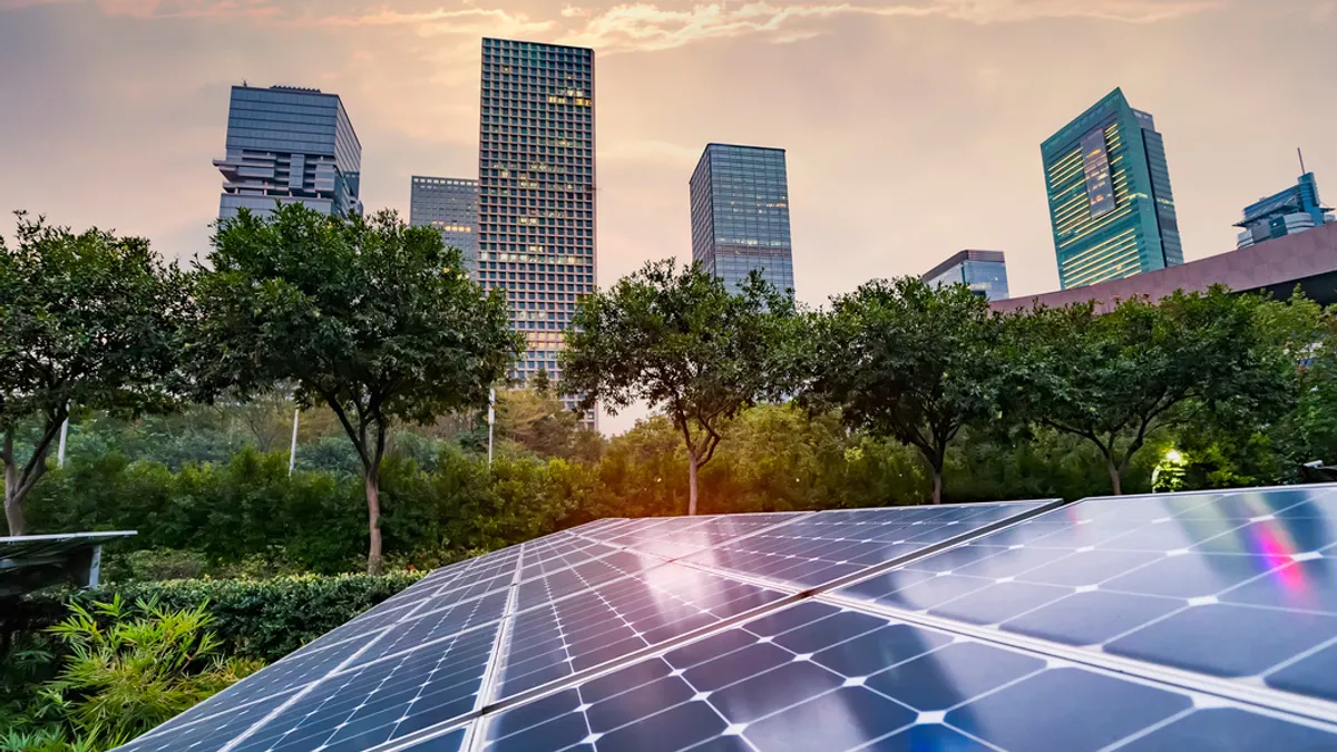 Ecological energy renewable solar panel plant with urban landscape landmarks.