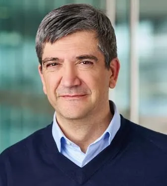 A corporate headshot of GM software executive Baris Cetinok
