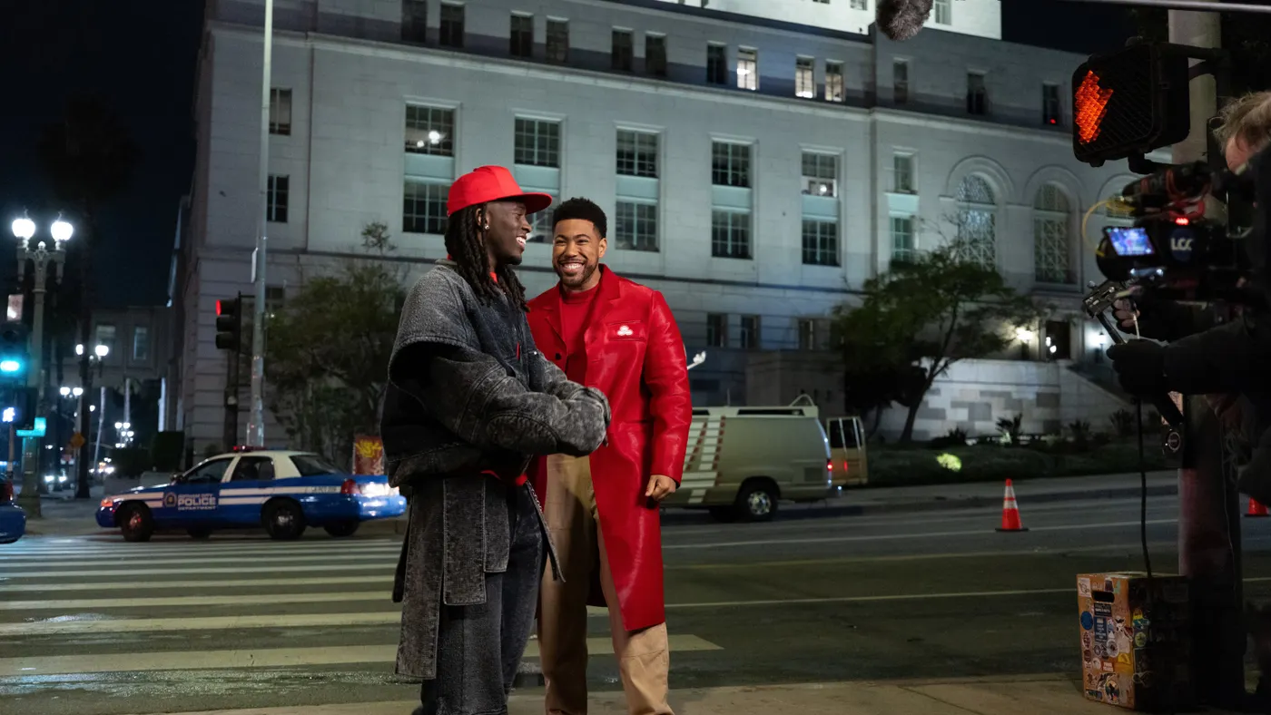 State Farm mascot Jake from State Farm stands with influencer Kai Cenat outside while on set for the brand's "Batman vs. Bateman" campaign.