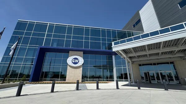 The front of an office building with windows and GlobalWafers blue and white logo sign in the center.
