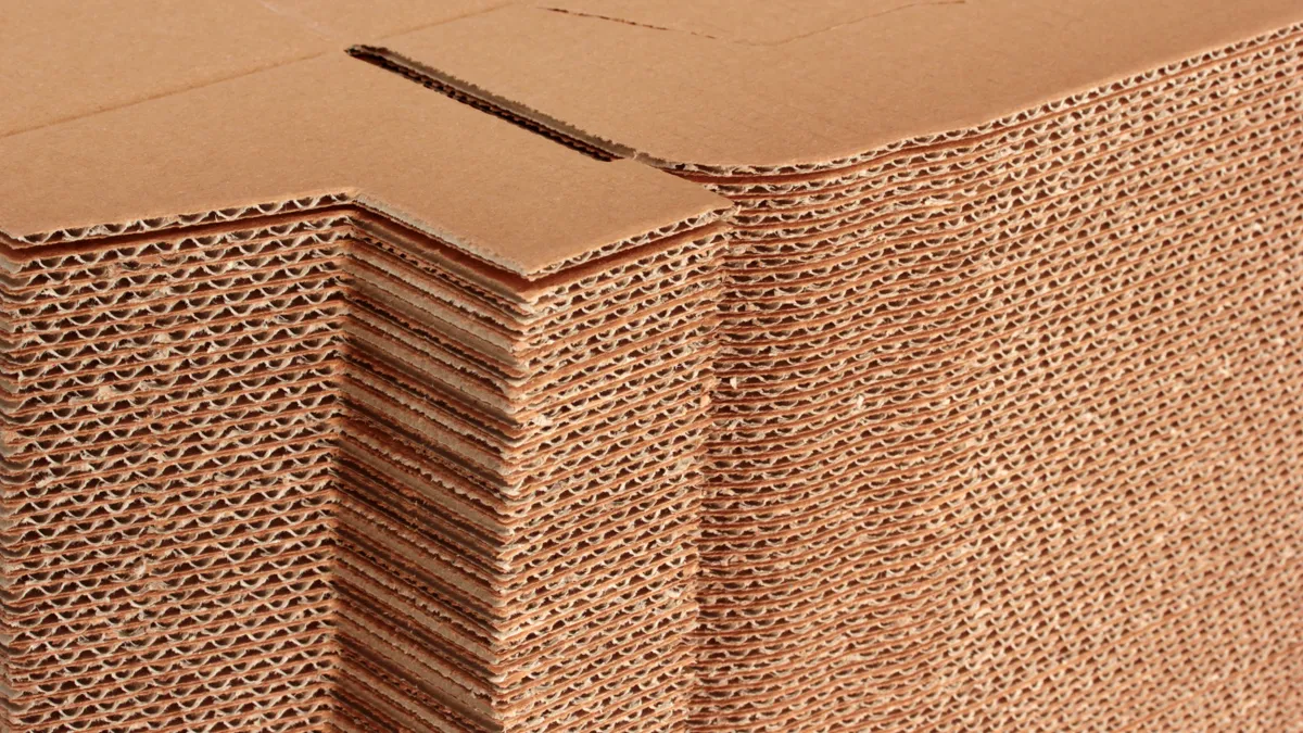 Close-up view of flat, stacked corrugated boxes.