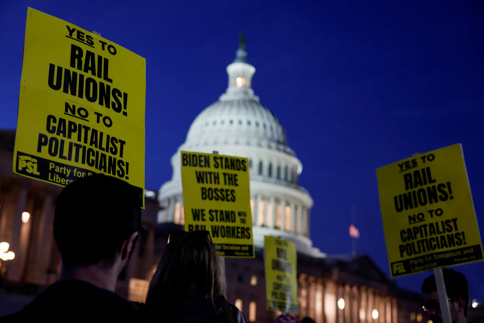 Signs with messages such as "Yes to Rail Unions! No to capitalist politicians!" is seen in front of the U.S. Capitol