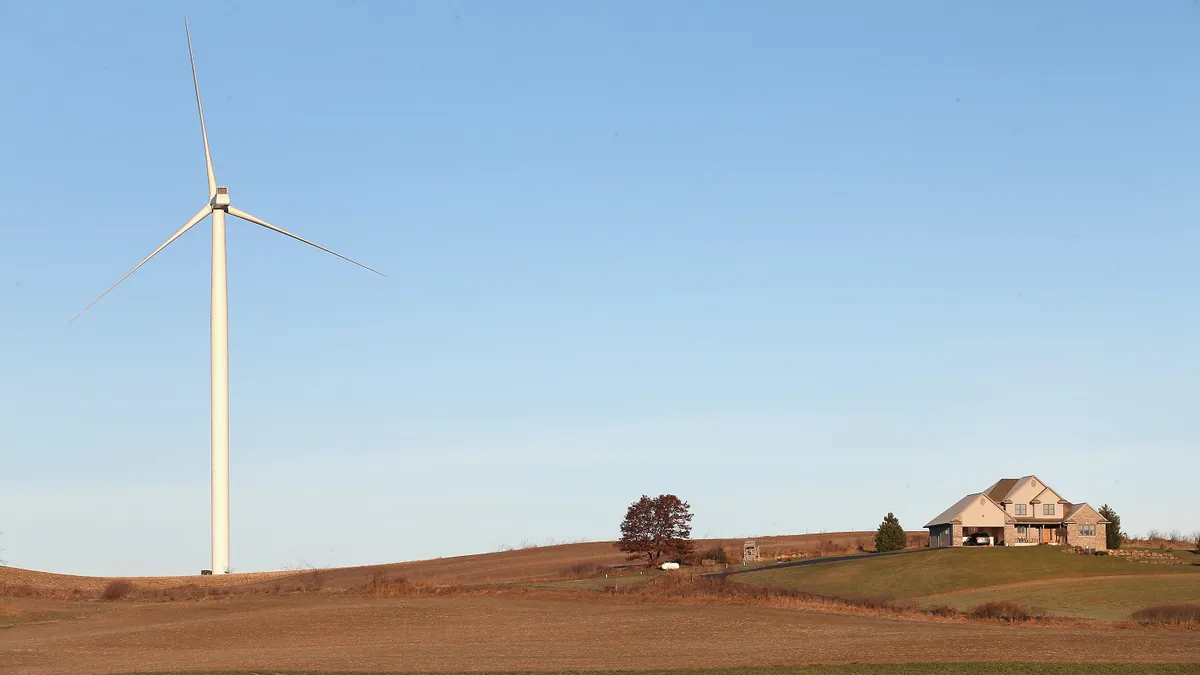 A wind turbine rises up above farmland in rural Wisconsin.