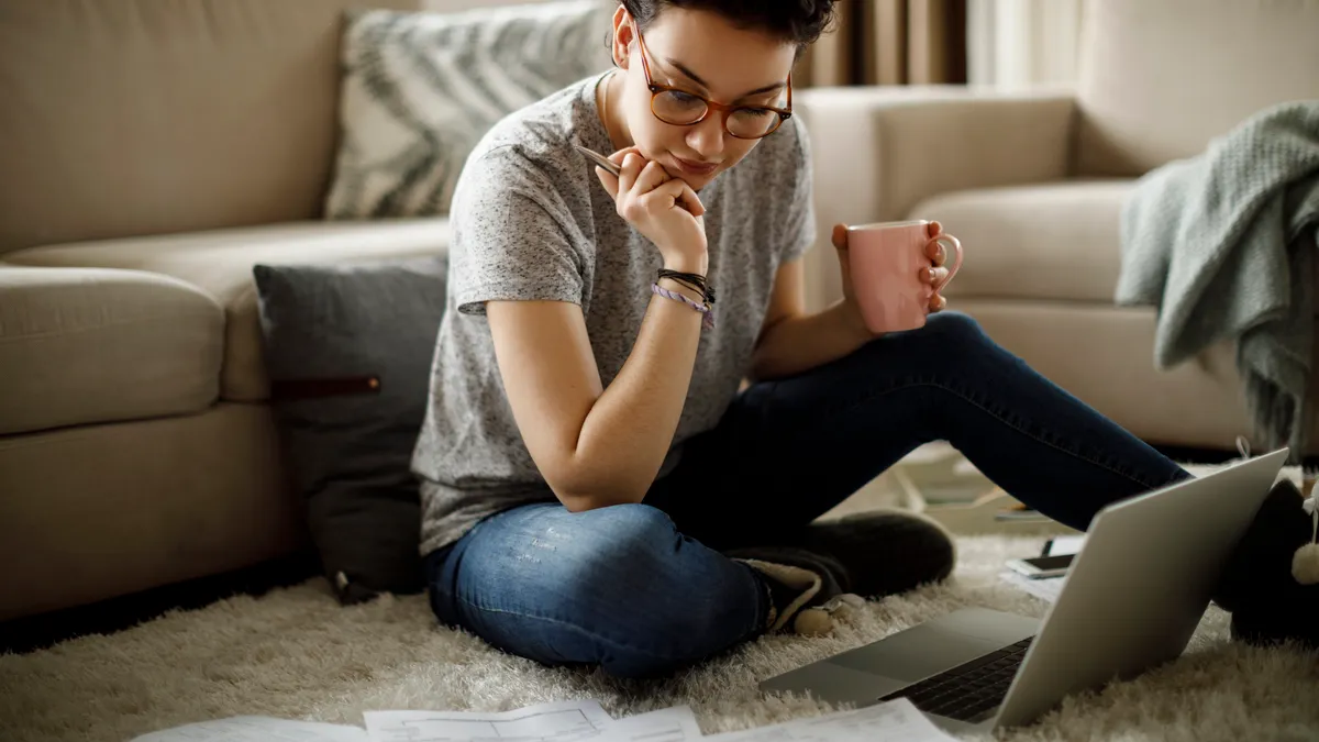 Young woman working at home - stock photo