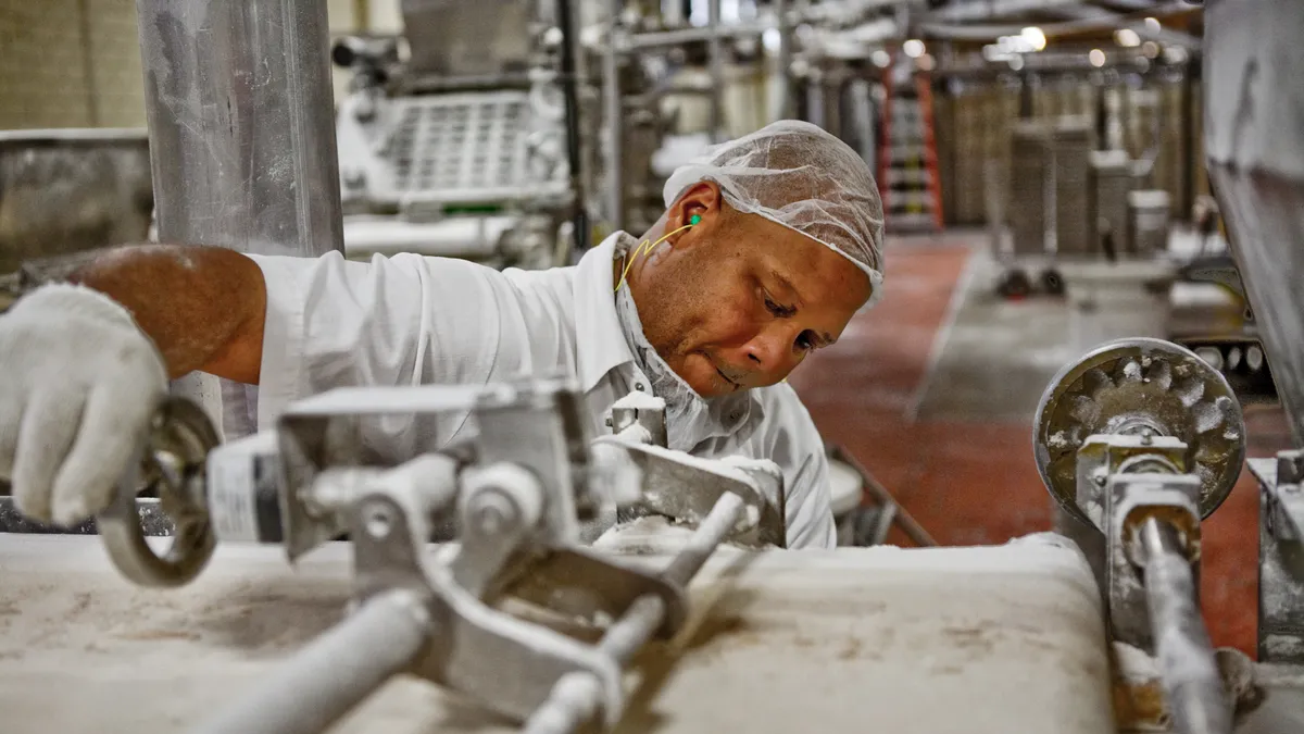 A man works at a baked goods manufacturing plant