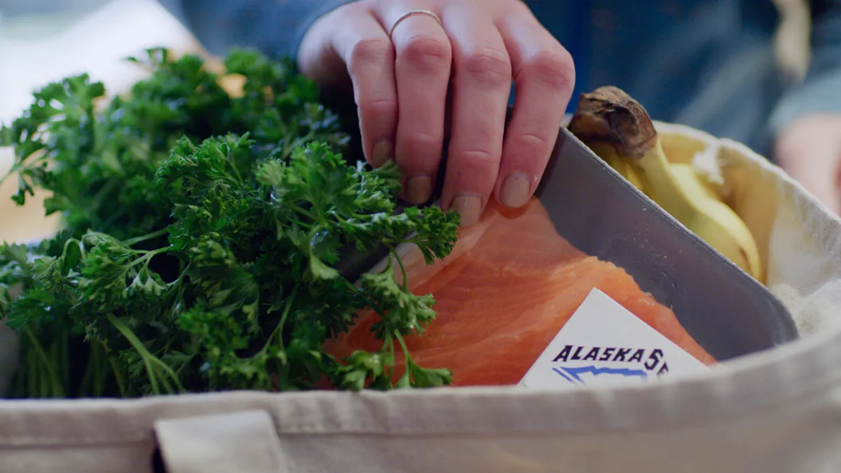 A grocery bag with fresh seafood from Alaska.