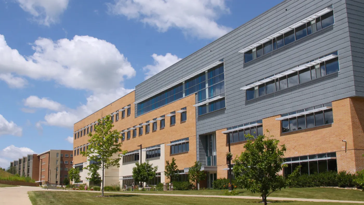 Education building with lawn and trees.