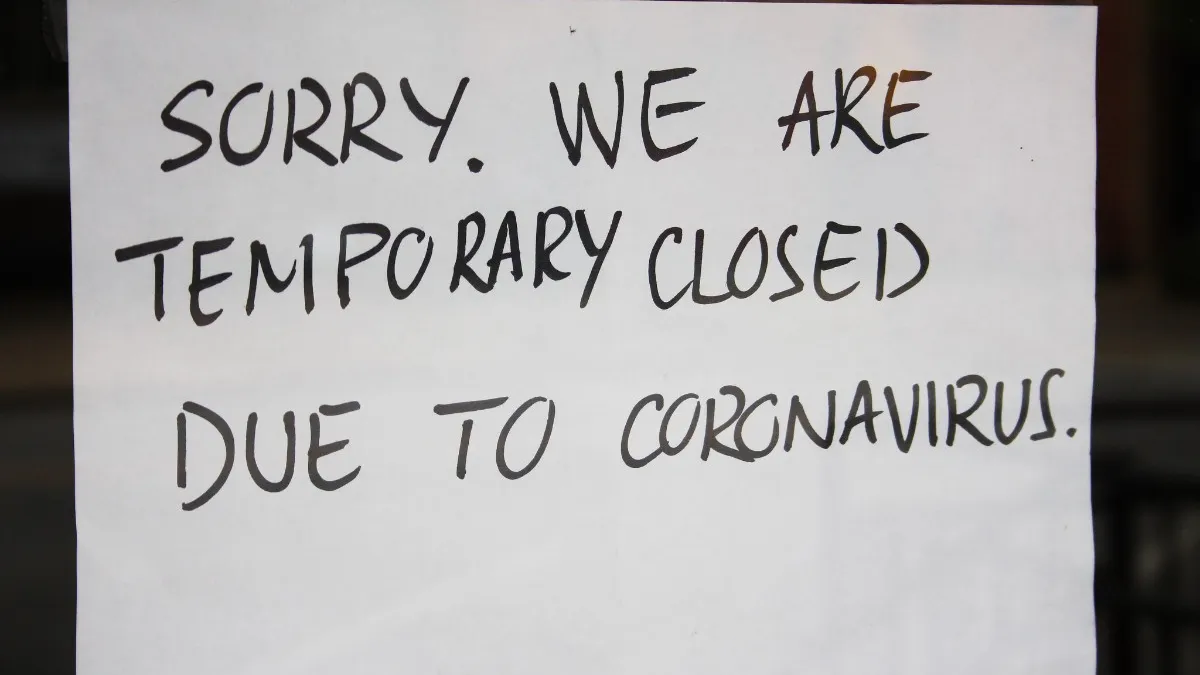 Closed sign outside of a small business during the coronavirus pandemic of 2020.