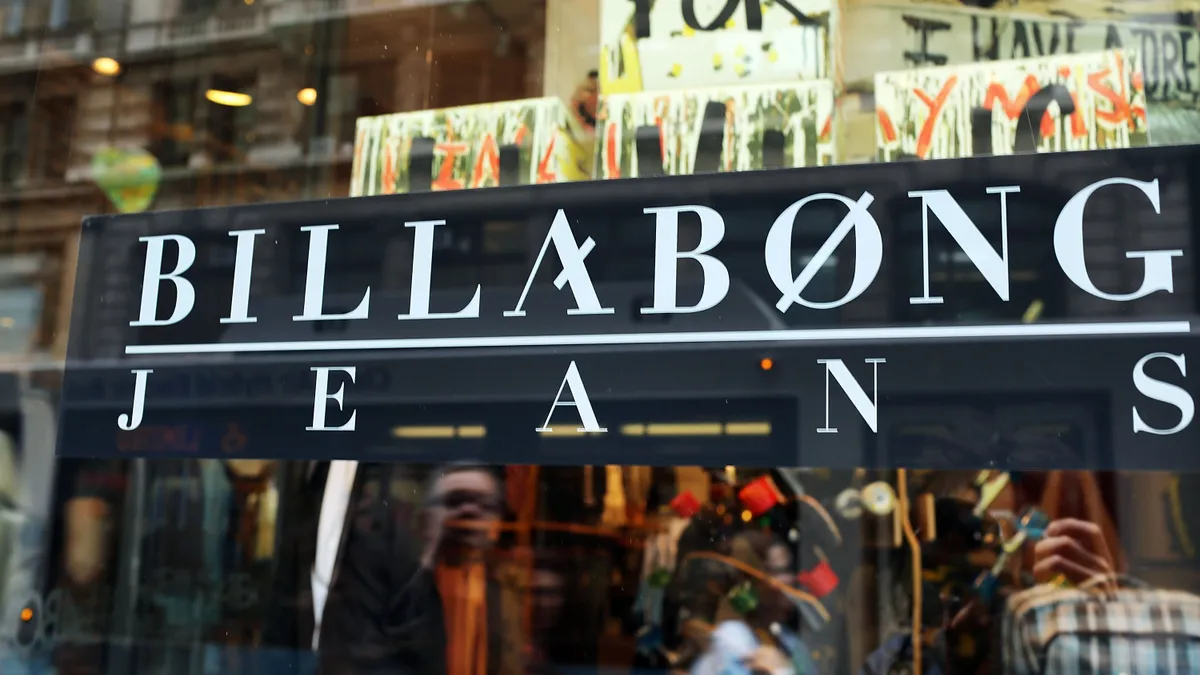 A billabong storefront is pictured as people walk around it.