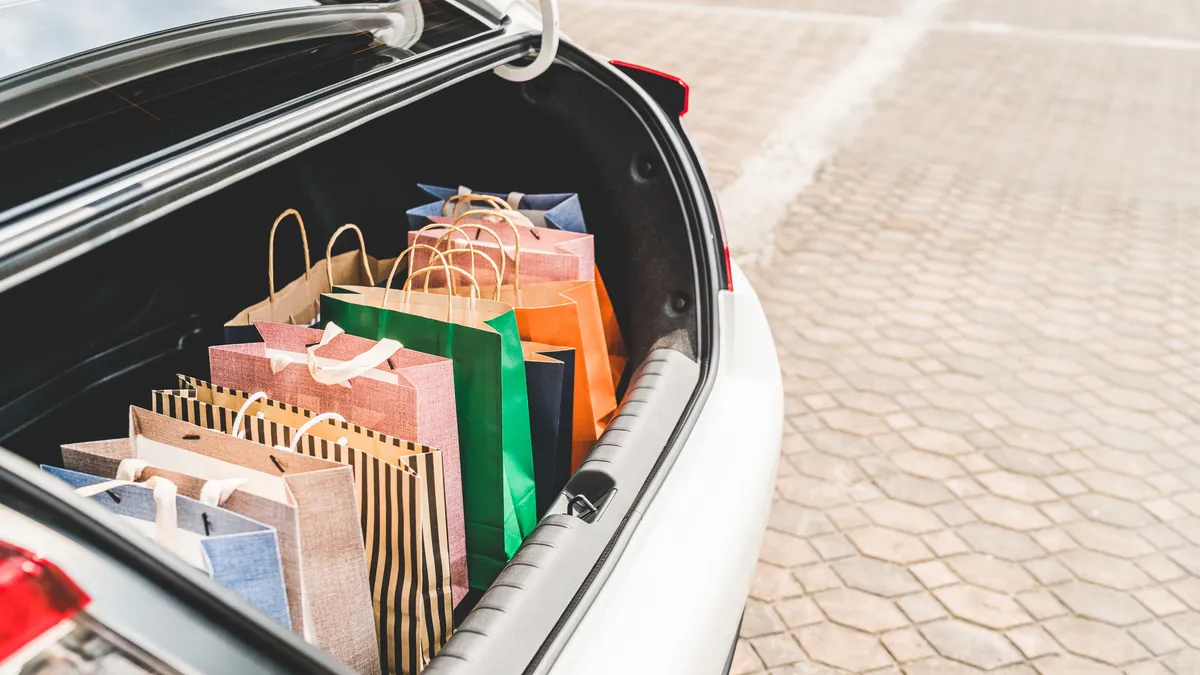 Shopping bags in car trunk with copy space. Modern shopping lifestyle, rish people or leisure activity concept