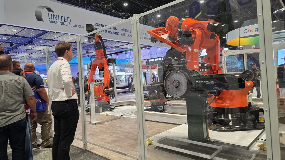 robots sit on the floor of a display area at IMTS 2026