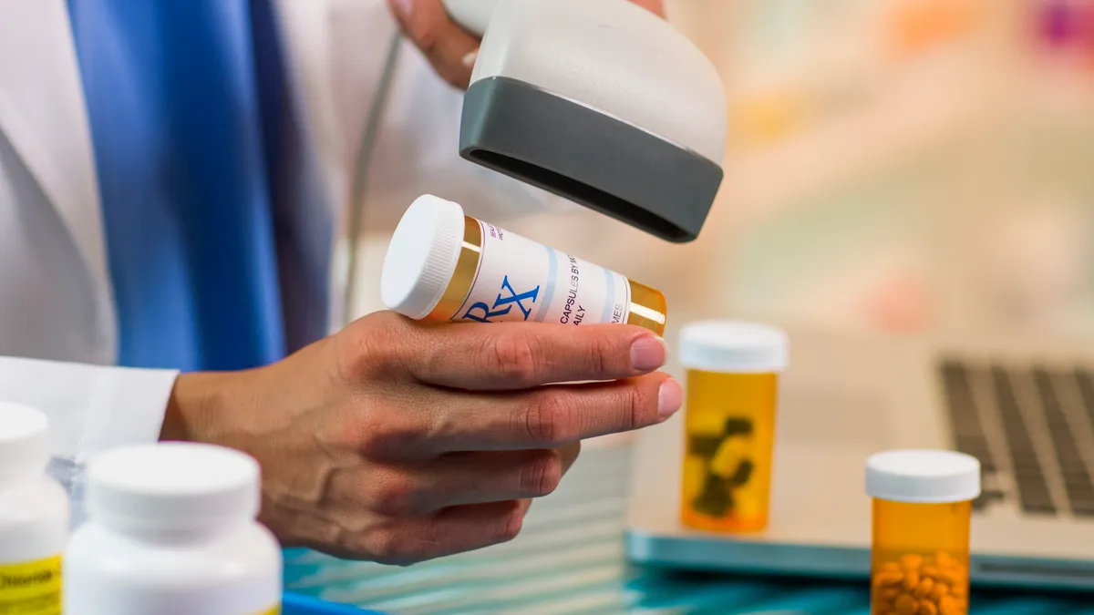 pharmacist scanning prescription