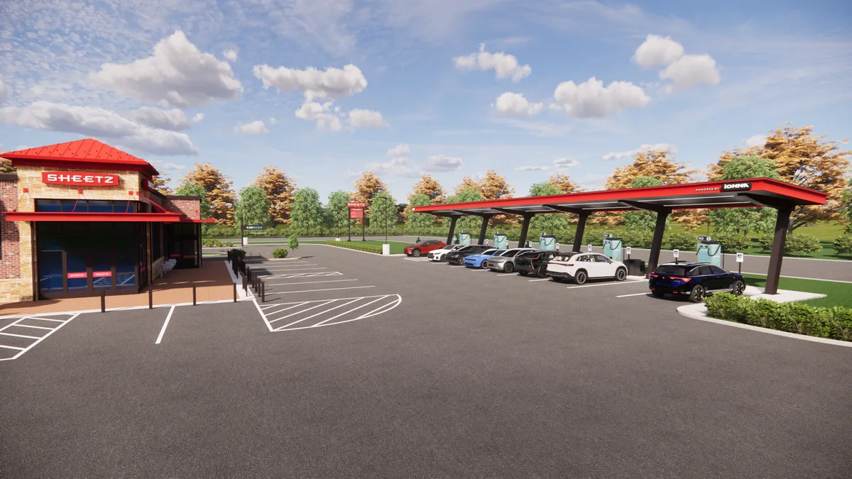 A rendering of a building in a parking lot. A sign above the door says "Sheetz." A canopy off to the side has a sign that reads "Ionna" and has a number of EV chargers and cars beneath it.