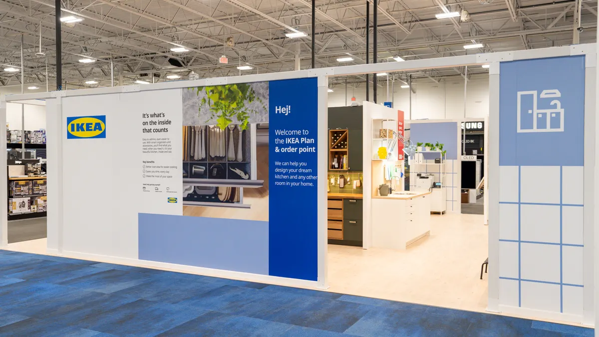 A blue and white Ikea shop-in-shop inside of a Best Buy storefront.