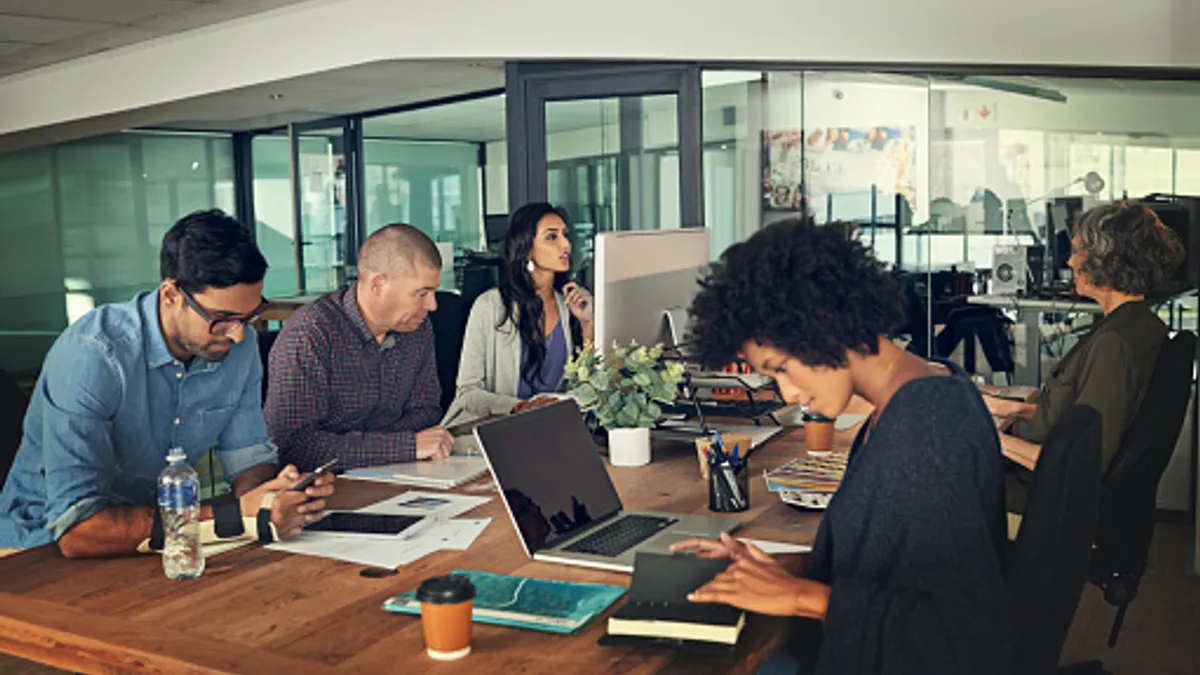 Cropped shot of a group of businesspeople working in an office