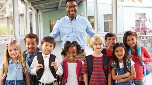 Teacher standing with his students