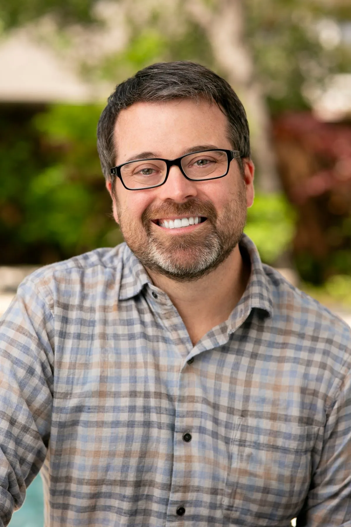 PepsiCo Foods Chief Creative Officer Chris Bellinger wearing a checked button-up and glasses