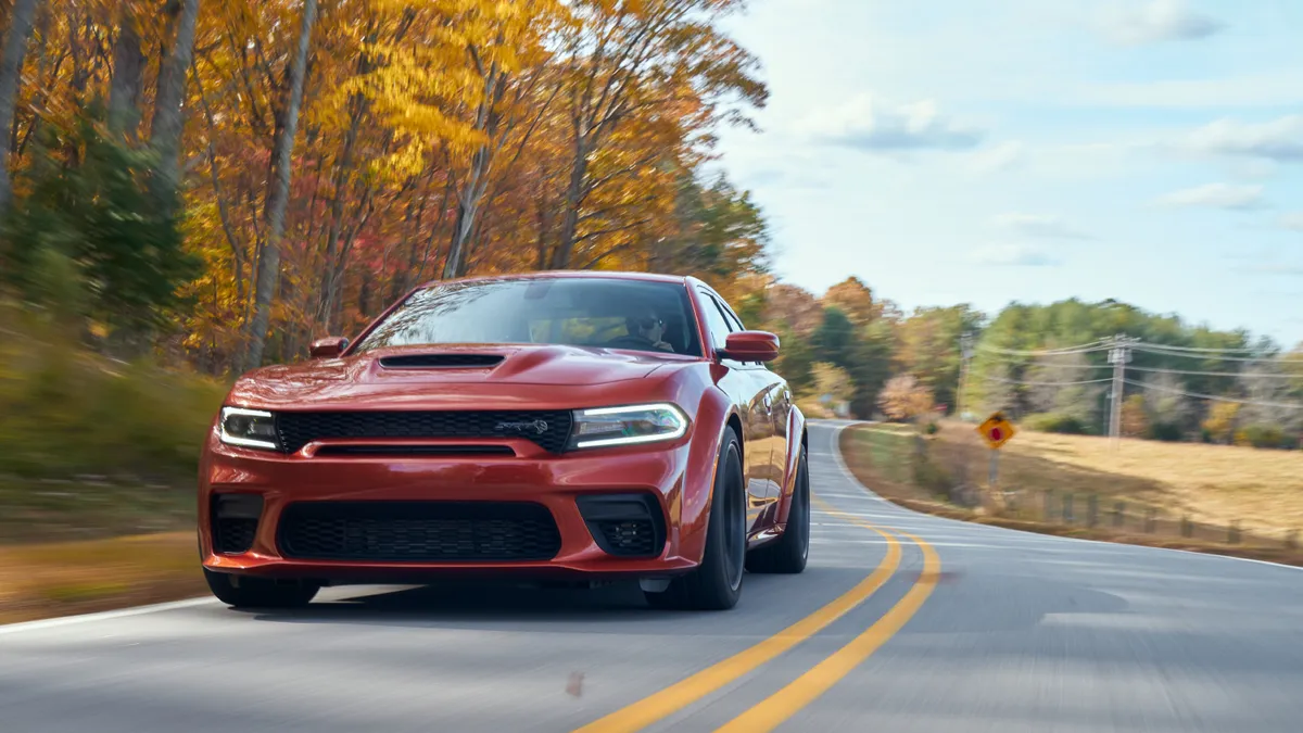 A 2023 red Dodge Charger SRT model on the road.