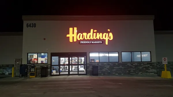 Exterior of Harding's Friendly Markets grocery store at night