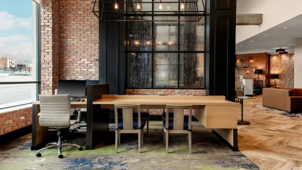 A table with desks in a hotel lobby.