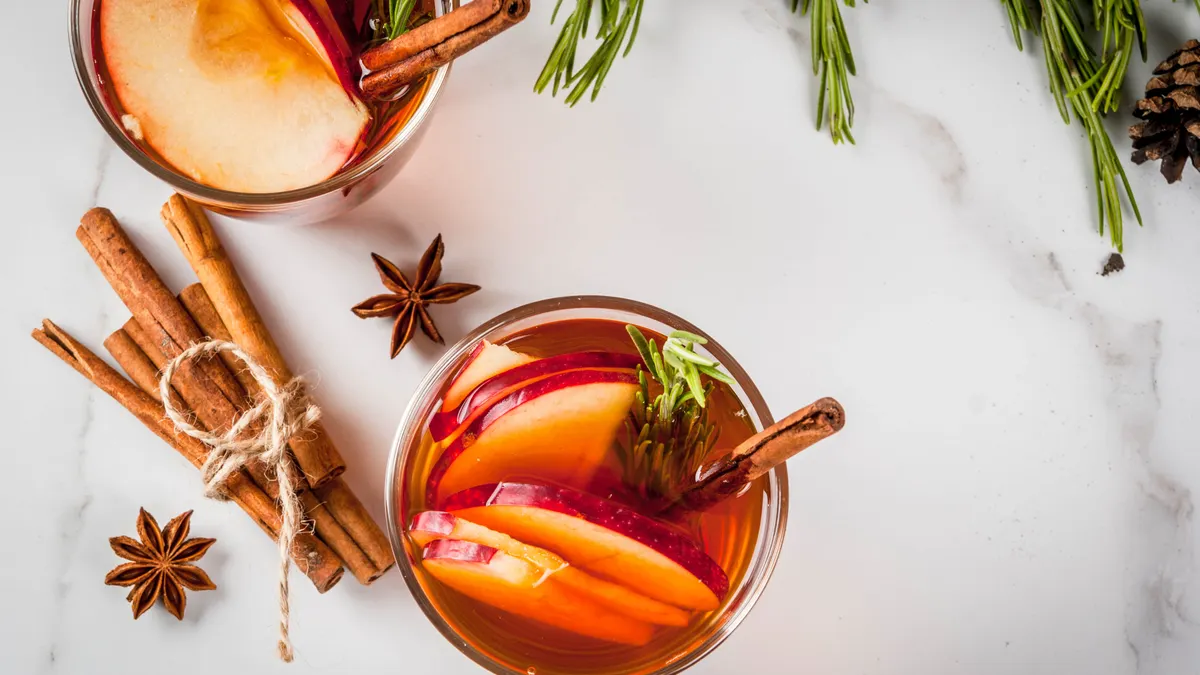 Hot cocktail with apple, rosemary, cinnamon