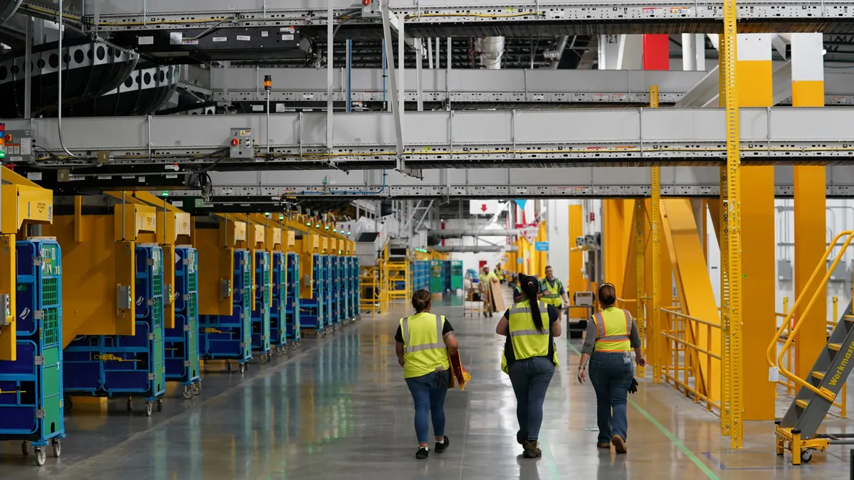 Workers walk through Amazon's robotics fulfillment center in Elkhart, Indiana.