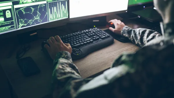 An American solider sits at a desktop computer at a U.S. army base.