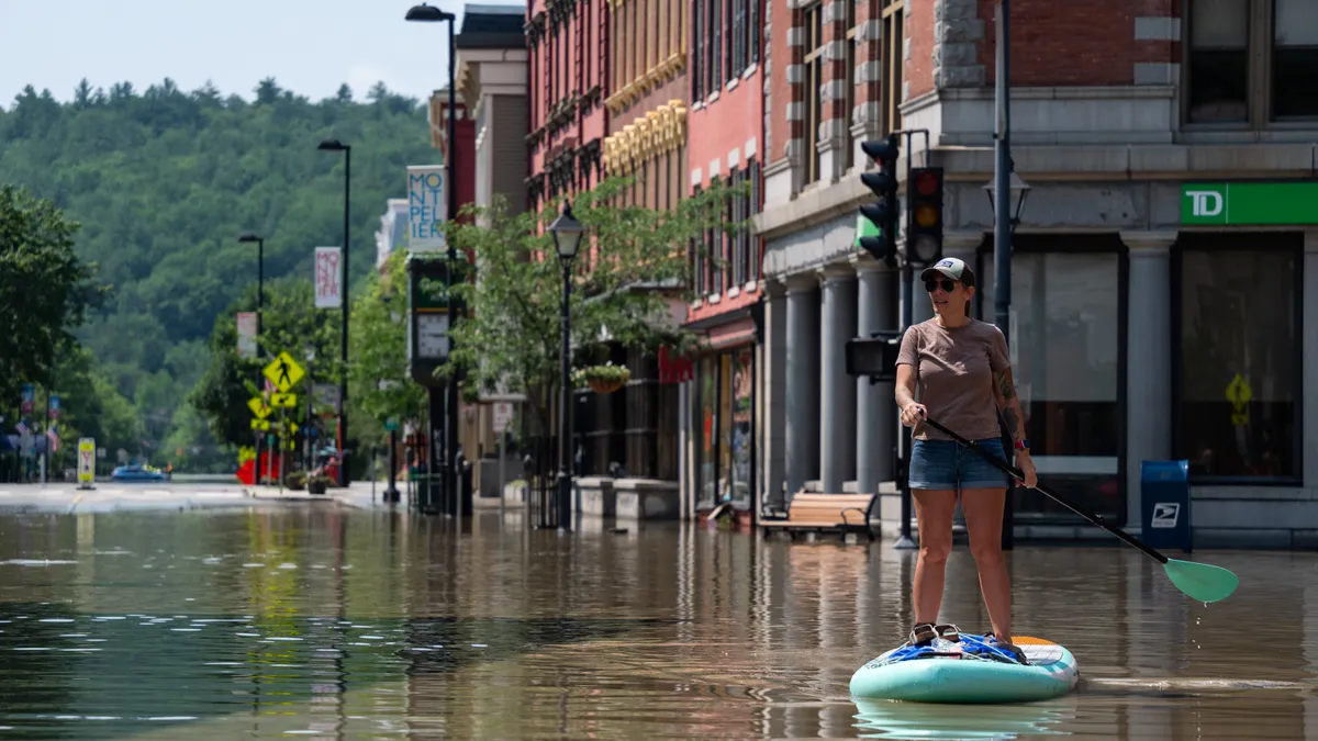 Montpelier resident Lynnea Timpone paddle boards in Montpelier, Vermont, on July 11, 2023.