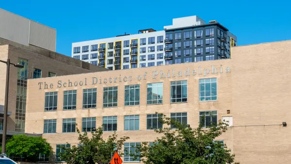 The exterior of a brick building that says "The School District of Philadelphia" at the top.
