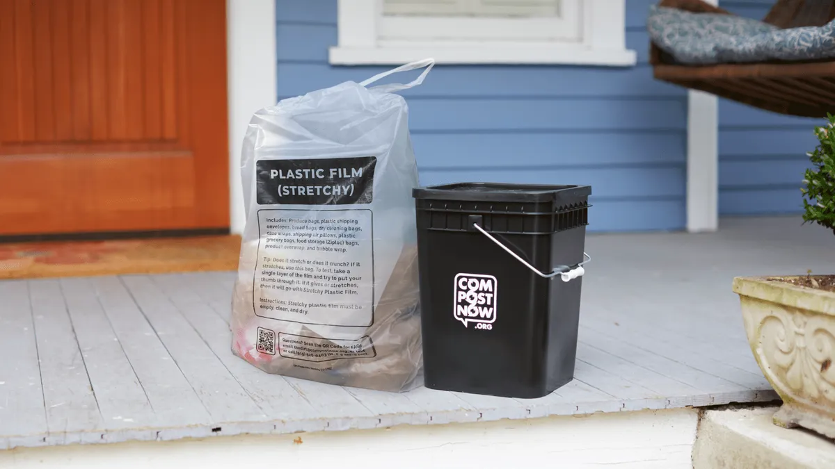 A clear bag labeled "Plastic Film (Stretchy)" sits next to a bin branded with the logo of CompostNow on a front porch.