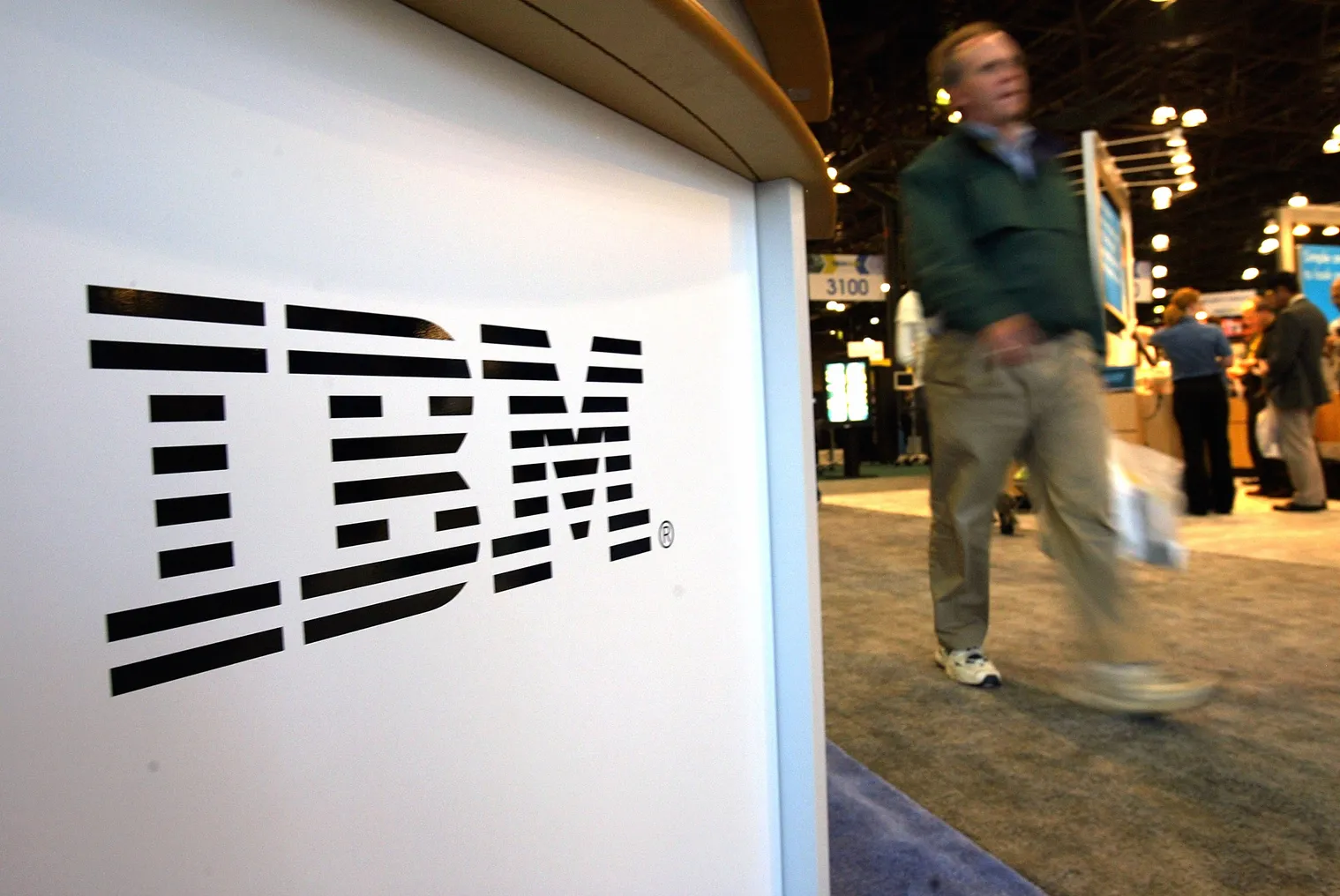 A person walks past an IBM sign October 5, 2004 at the TECHXNY show in New York City.