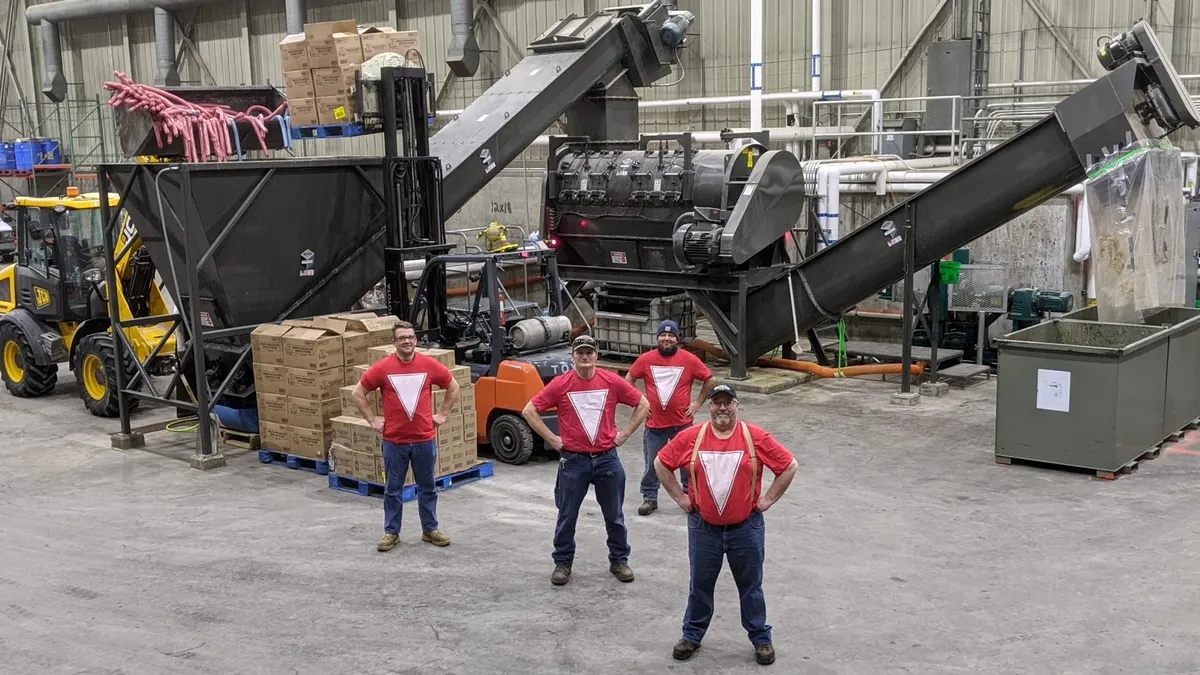 Men standing in front of heavy equipment