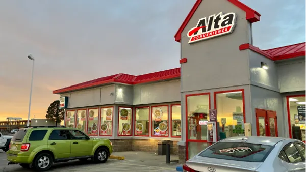 A photo of the exterior of a store. A sign on the store says Alta Convenience.