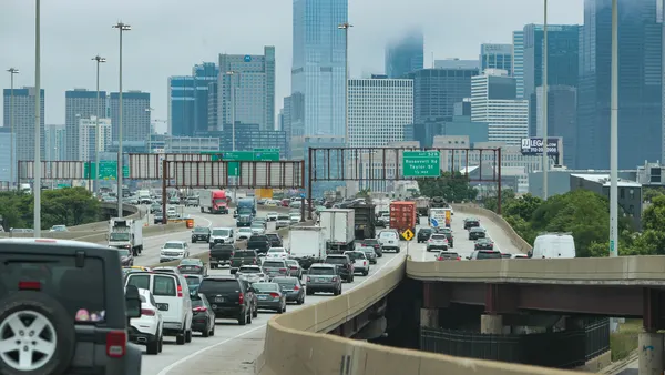 Traffic backed up on a highway in Chicago in 2023 with the cityscape in the distance.