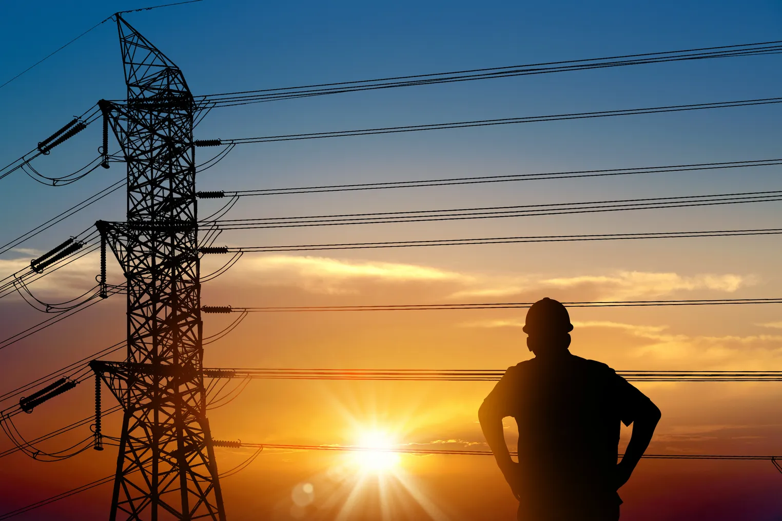 Electrician worker and electricity power lines over sunset sky.