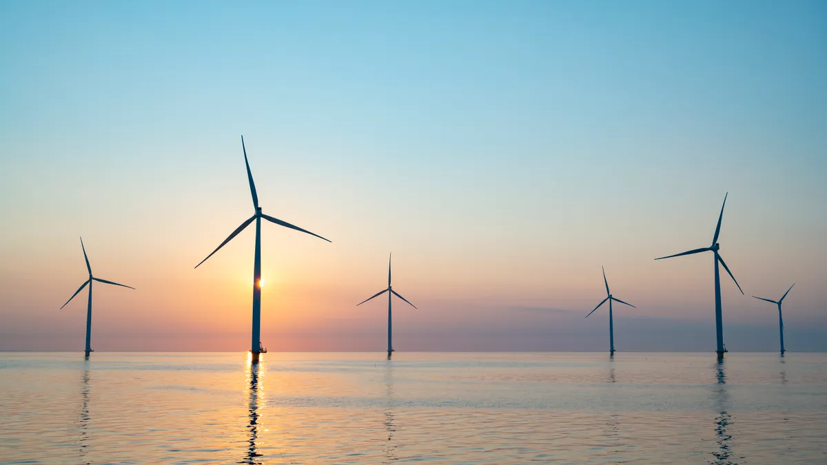 Turbines in an offshore wind park in Flevoland, The Netherlands, at sunset.