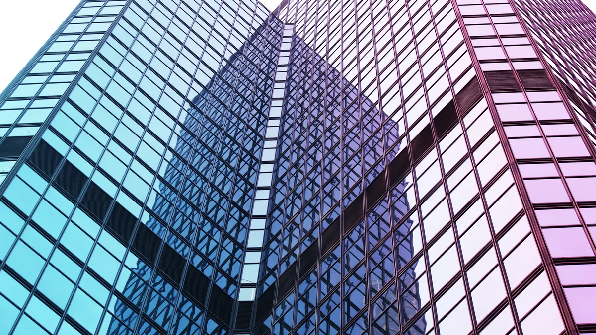 Reflection and lines formed by two modern glass architecture.