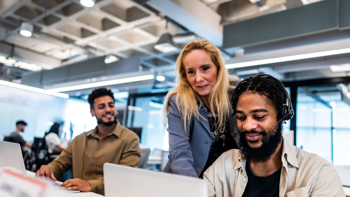 Boss talking with employee in a contact center.