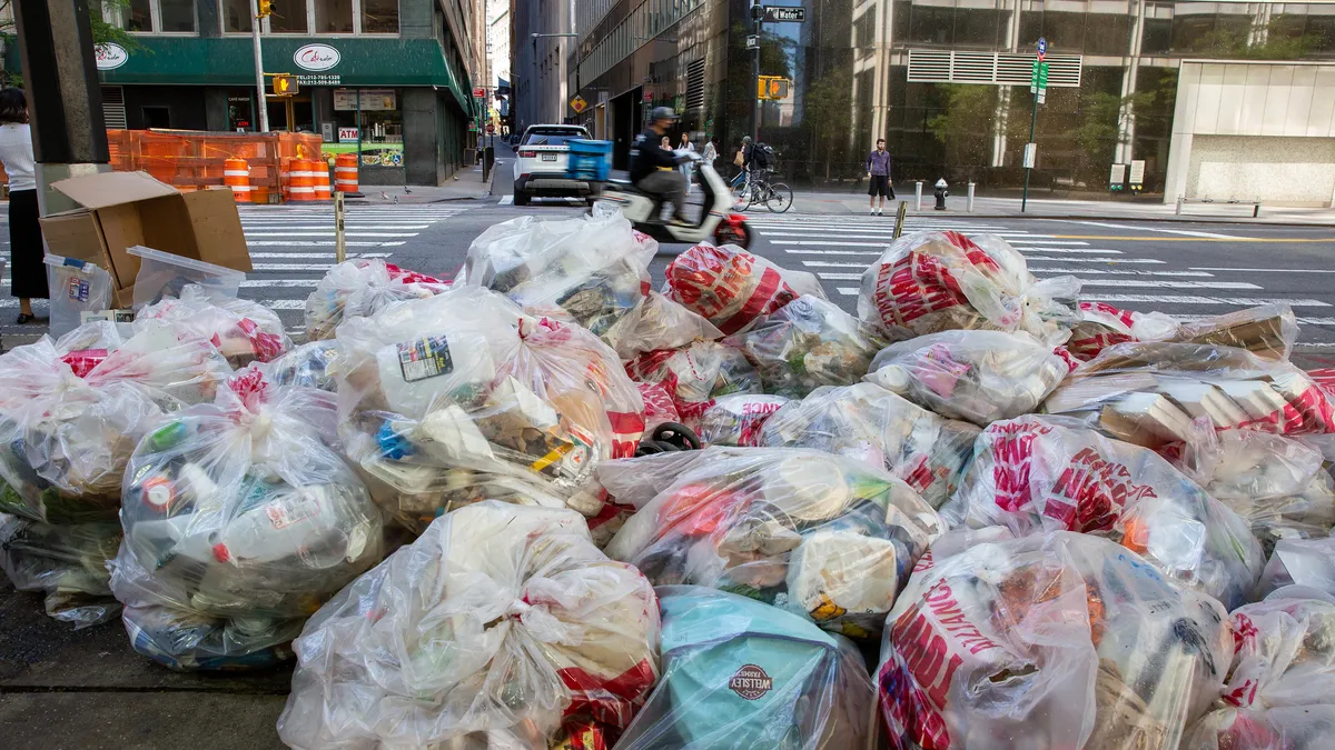 Pile of clear plastic bags full of waste/recycling on a street in New York