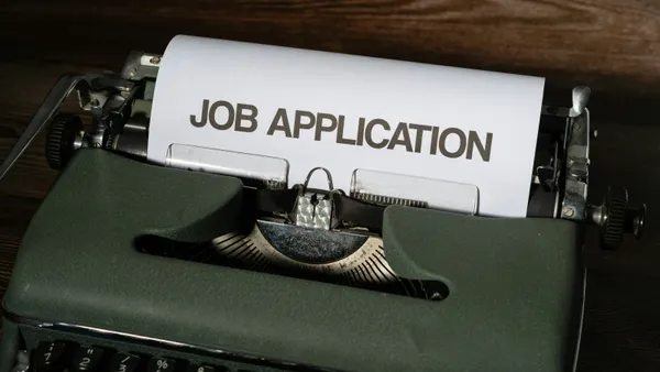 A typewriter with job application printed on it