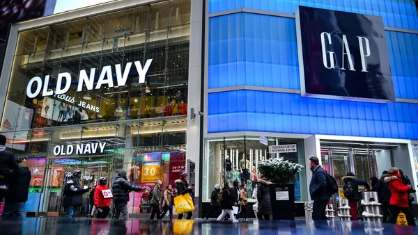 Pedestrians walk past Old Navy and GAP stores in Times Square