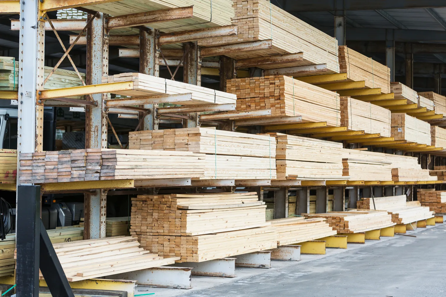 Lumber supplies sit on shelves in a construction supply store.