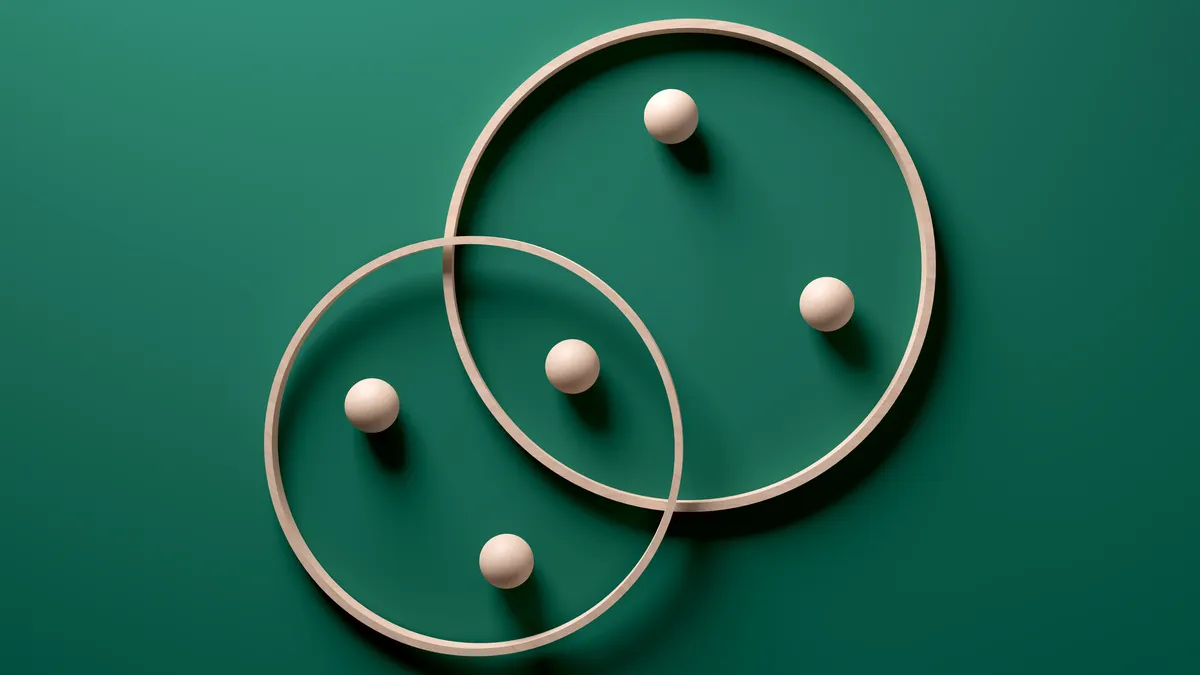 Crossing wooden rings with spheres on green background. Modern abstract art with geometric shapes.