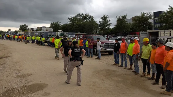 A group of construction workers lined up on a construction jobsite.