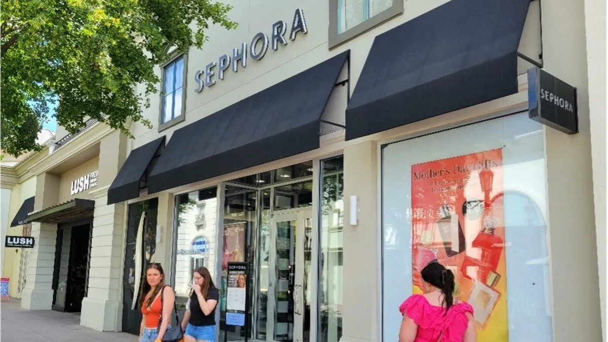 People at an outdoor shopping center.