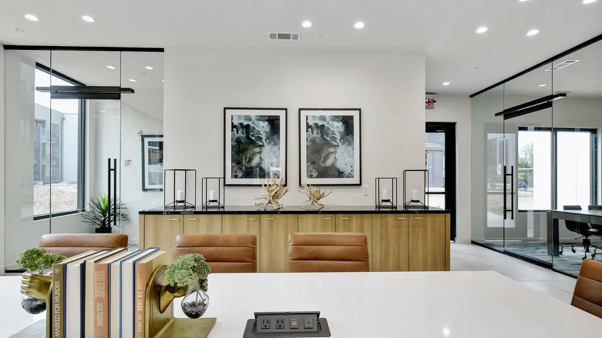 A white room with tables and chairs.