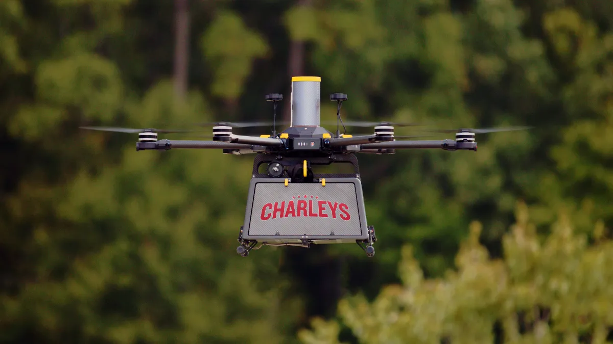 An image of a drone in flight with the logo Charleys on the side