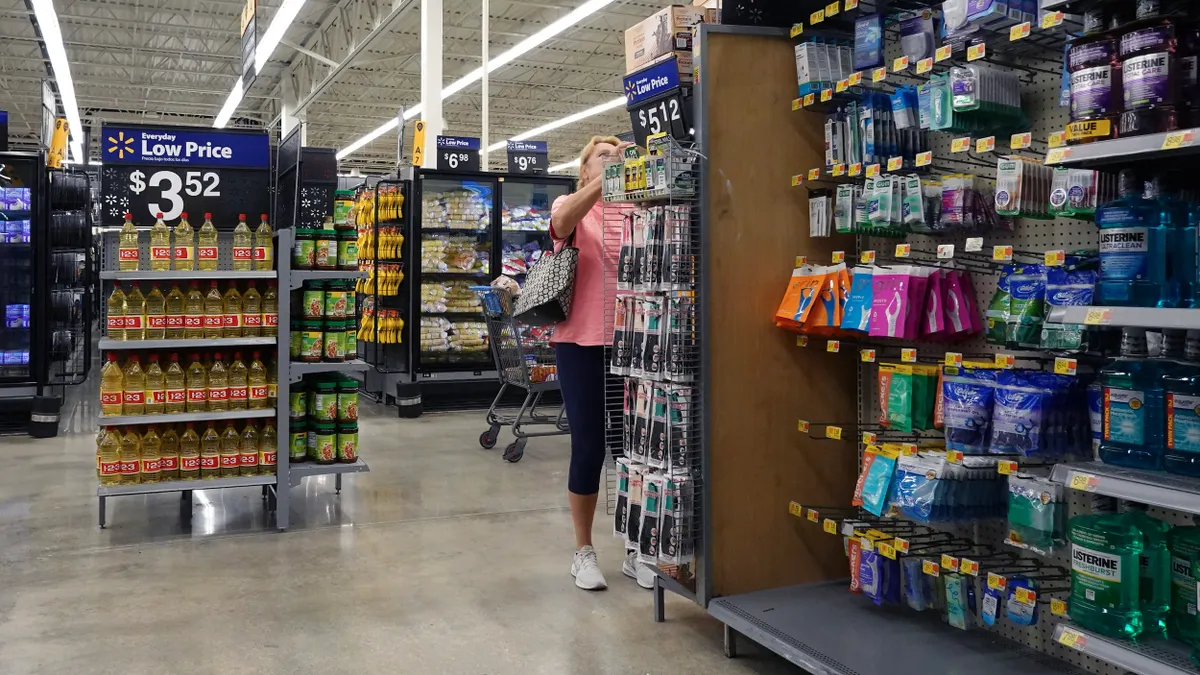 A person shops at a Walmart in Florida, next to an aisle of personal care products