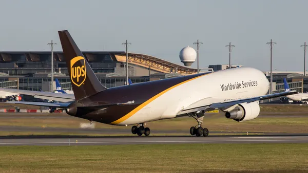 A UPS plane travels on a runway.