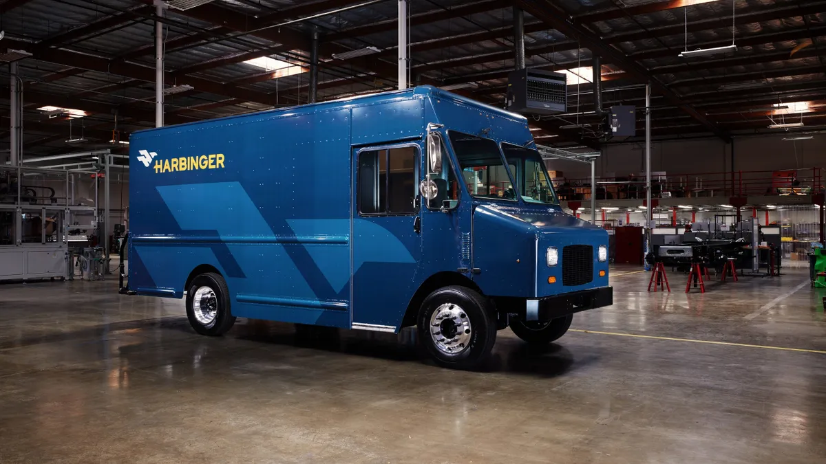 A Harbinger medium-heavy EV stands in a facility.